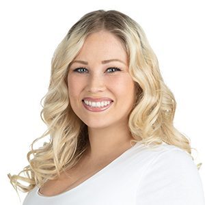 A woman with blonde hair and white shirt.